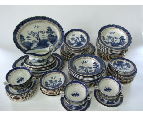An extensive collection of Booths Real Old Willow pattern blue and white printed dinner wares comprising three oval meat plat