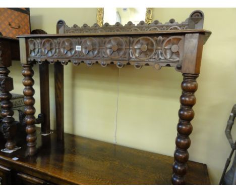 A Victorian oak hall table of rectangular form with geometric carved detail raised on bobbin forelegs