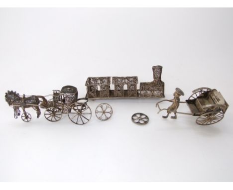 A collection of novelty Indian/Asian white metal items to include a filigree train, and horse drawn carriage together with a 