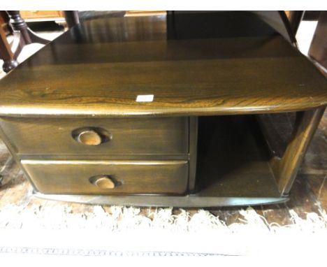 An Ercol dark elm Pandora's Box coffee table, 40 cm high x 83 cm long approx