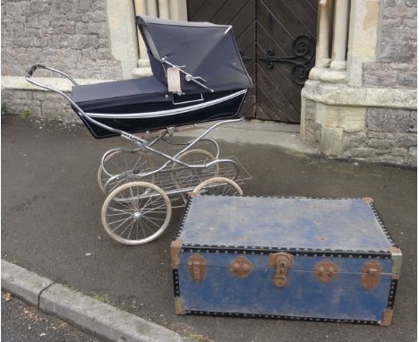 A vintage coach built pram with chrome framework together with a blue vintage travel trunk