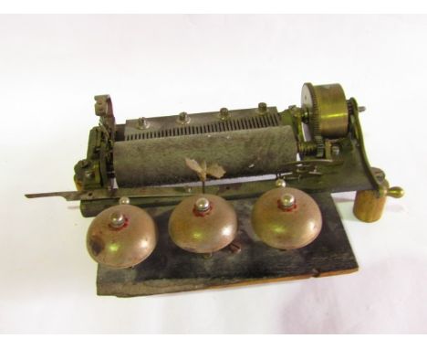 Musical box workings to include three bells, comb and reel, one of the bells fitted with a dragonfly striker, 33cm wide