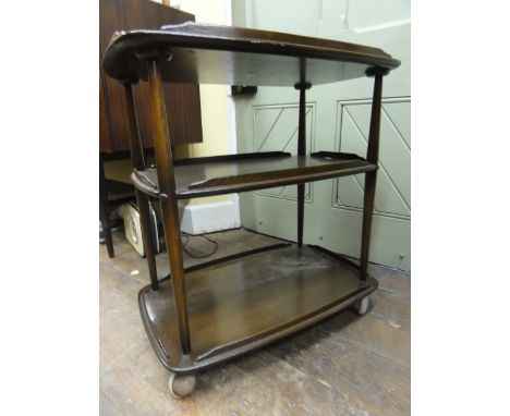 An Ercol dark elm three tier tea trolley, 79 cm high x 72 cm long approx