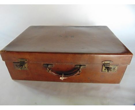 A vintage leather suitcase with brass brahma lock by John Pound & Co, Oxford Street