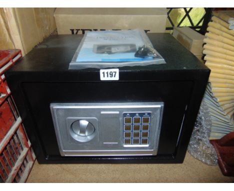 An unused household safe with instruction manual, key etc