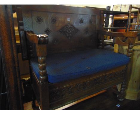 An Edwardian oak monks bench of usual form with box seat, bobbin moulded detail and geometric carved decoration