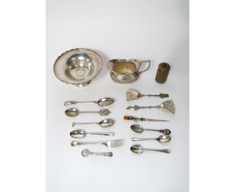 A collection of silver items to include a small tazza on stepped foot, a milk jug with half fluted  decoration, novelty silve