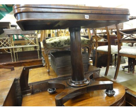 A Victorian rosewood fold over top card table of rectangular form with rounded front corners raised on a simple central inver