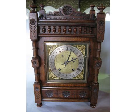 A German walnut ting tang two train shelf clock within an architectural case with turned columns and flower head roundels, fi