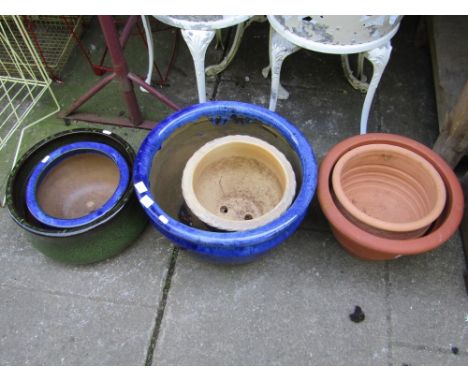 A dark blue glazed open planter and five other various pots
