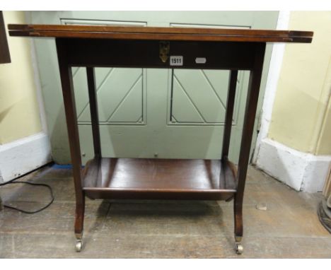 A good quality Edwardian mahogany fold over top card table of rectangular form with brass locking catch, raised on four squar