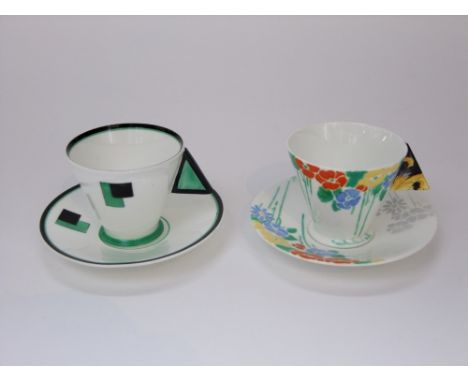 Two Shelley art deco coffee cups and saucers, one with green and black geometric design and triangular shaped filled handle a