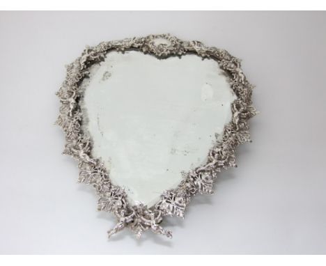 A good quality late 19th century heart shaped dressing table mirror, the silver plated frame decorated with cupids, masks and