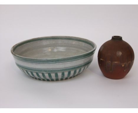 An early Poole Pottery open bowl with green striped decoration on a cream coloured glaze and with impressed rectangular mark 