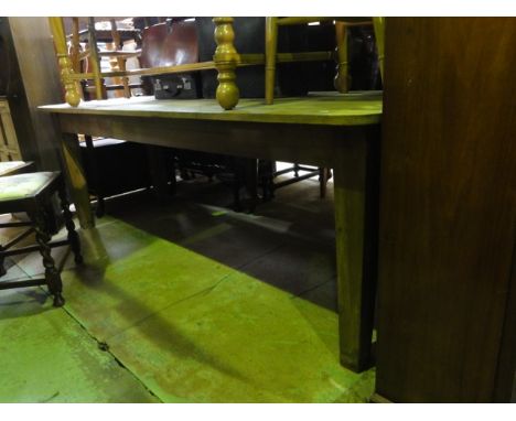 A vintage pine kitchen table, the rectangular planked top raised on four square tapered legs, 7ft long x 78cm wide approx