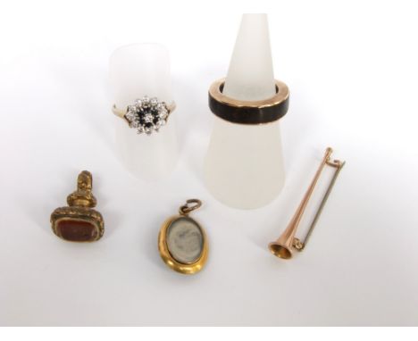 A small collection of 9ct gold items to include a trumpet pin brooch, a gentlemens ring and a cubic zircona and sapphire set 