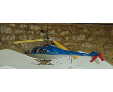 A Hirobo Corvette SST helicopter with remote control device and charger, with o.s. engine, servos and strobe landing lights -