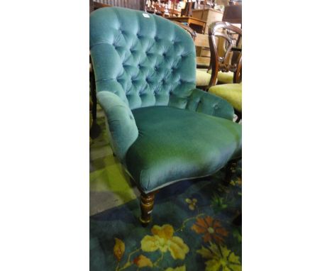 A Victorian style button back bedroom chair with blue upholstery and turned front legs