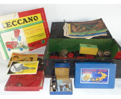 A collection of vintage meccano to include a boxed outfit number set and further booklet and spares within a wooden trunk