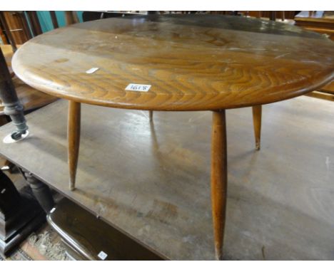 An Ercol Golden Dawn elm circular coffee table, 46 cm high x 76 cm diameter approx