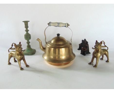 A pair of eastern brass drips in the form of lions, together with a galvanised metal candlestick, copper kettle and a resin f