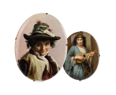 each hand painted, of oval form and in the manner of KPM, the larger depicting a young man in a hat, with impressed marks K2 