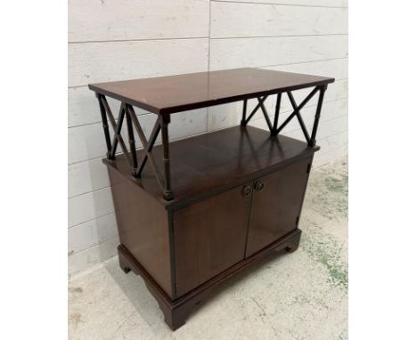 A mahogany two door music cabinet with shelf over (H76cm W70cm D40cm)