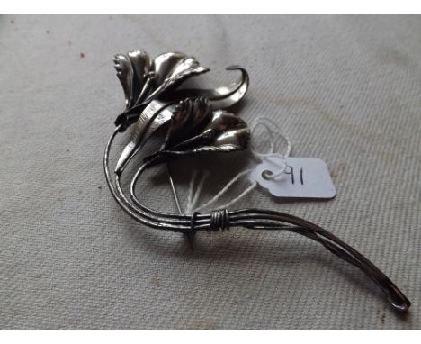 A large sterling silver brooch in the form of an orchid 