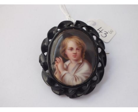 An oval portrait panel brooch in carved jet frame