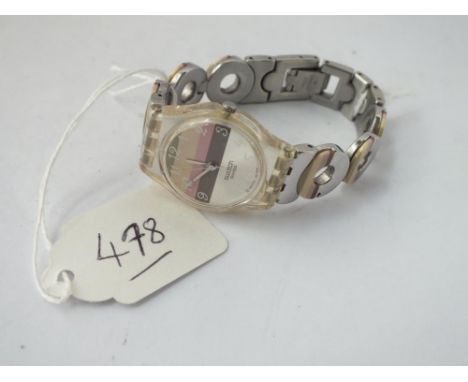 A ladies swatch watch with fancy strap 