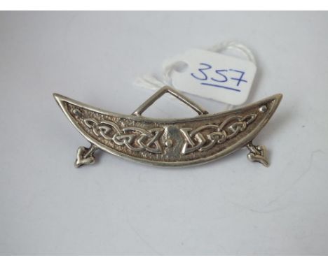 A silver Celtic style crescent brooch