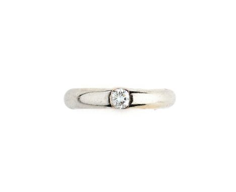 CARTIER: DIAMOND AND GOLD RING, 1990s the tapering tubular band centring on a brilliant-cut diamond, signed Cartier, numbered