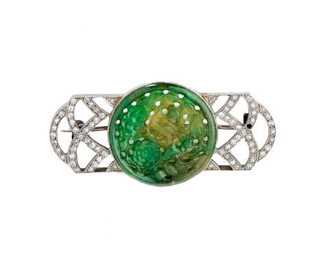 JADE AND DIAMOND BROOCH, 1920s centring on a circular jade plaque carved to the obverse and reverse with birds amongst floral