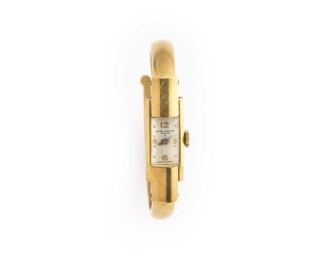 BAUME ET MERCIER: A LADY'S GOLD BANGLE WATCH, CIRCA 1950 manual wind 17 jewel movement, silver dial with Arabic numerals to q