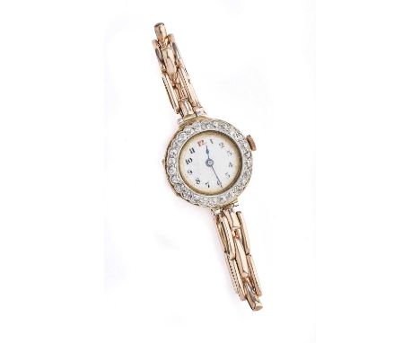 A LADY'S DIAMOND AND GOLD WRISTLET WATCH, SWISS, CIRCA 1914 the circular white enamel dial applied with Arabic numerals, to a