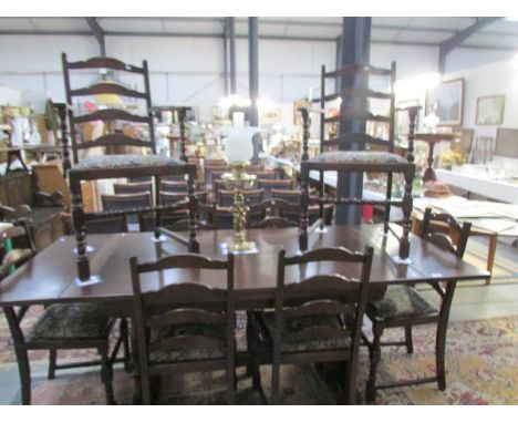 An oak extending dining table and a set of 6 ladder back chairs 1 A/F & 2 carvers