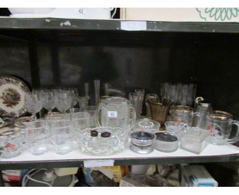 A shelf of assorted glass ware