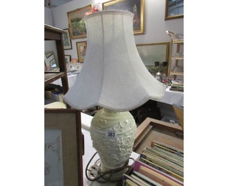 A ceramic table lamp with shade