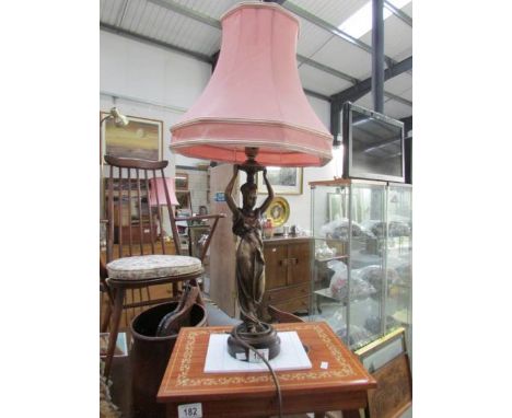 A figural table lamp with shade