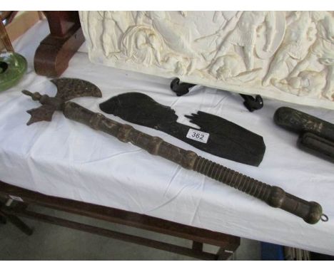 A Wooden relief figure of a woman and a tribal axe
