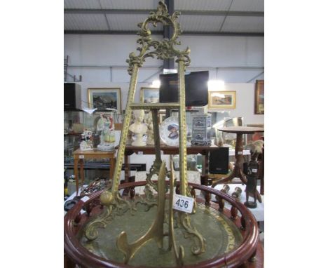 A brass easel and a brass plate stand