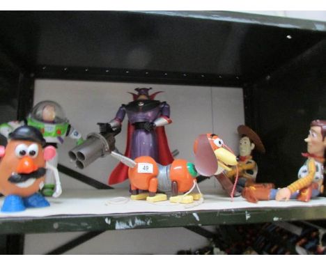 A shelf of Disney toys including Toy Story