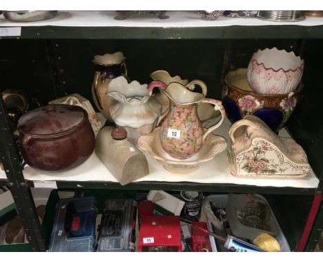 A shelf of miscellaneous including jug and basin sets, cheese dish etc