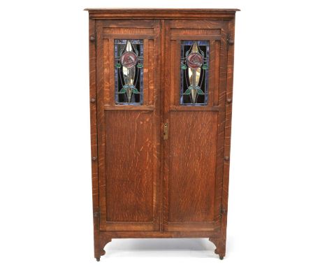 Arts and Crafts Oak Cabinet Early 20th century Arts and Crafts oak cupboard or wardrobe, moulded cornice over two doors each 