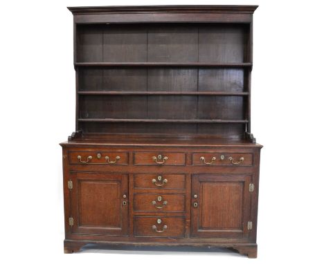 George III Welsh oak dresser George III Welsh oak dresser, planked back supporting three long pot shelves, the rectangular ba