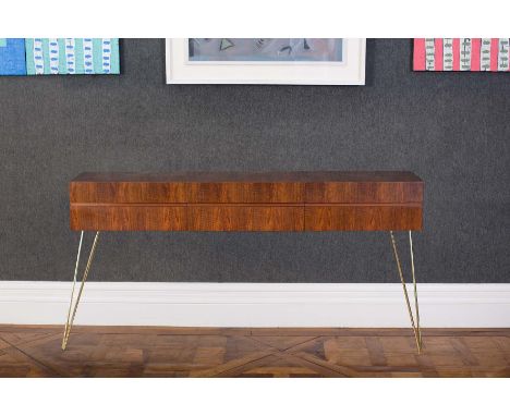 A ROSEWOOD CONSOLE TABLE, ITALIAN, 1960s, with central frieze hinged drawer, lifting to reveal a shelf, raised on brass taper