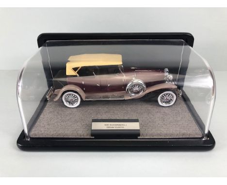 Franklin mint 1987 model of a Duesenberg Tourster motor car in its display case approximately 28cm long overall 