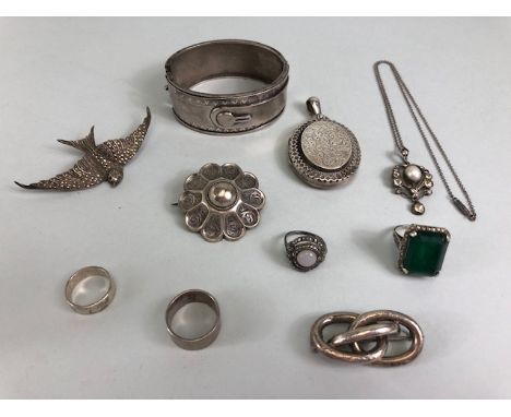 Antique and Vintage silver jewellery collection to include a large oval locket with engraved design, a Scottish style wheel b