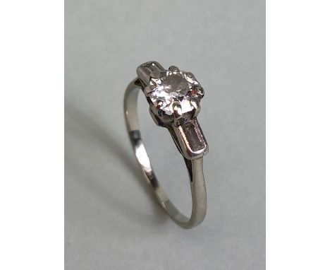 Antique jewellery, 18ct white gold (hallmark rubbed) diamond ring, central stone just under 1ct set either side with a baguet