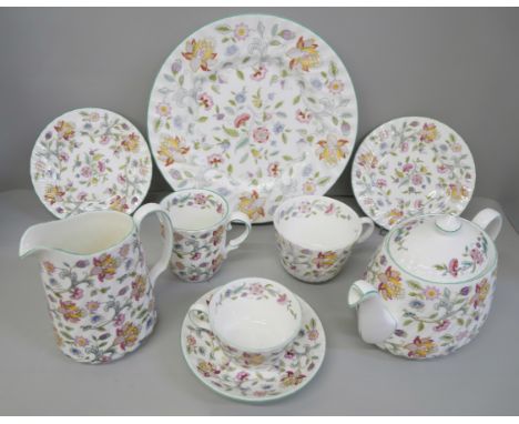 A Minton Haddon Hall dinner and tea service including twelve dinner, tea and side plates, some pieces worn and decoration fad
